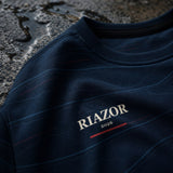 Detalle del pecho RIAZOR 2026 y textura del tejido reciclado de la sudadera