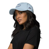 Gorra Fisterra CF Azul cielo - mujer con gorra en retrato premium lateral. Mockup oficial Printful, Costa da Morte.