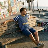 Modelo sentado con la camiseta Pacific Sun F.C. '94 Edición Sol frente al paseo marítimo
